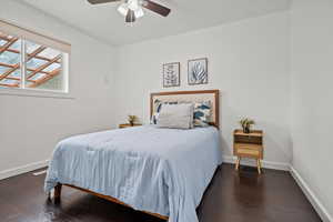 Bedroom with wood finished floors, baseboards, and ceiling fan