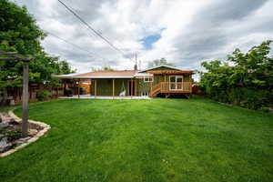 Back of house featuring a patio and a deck