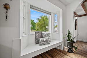 Living area with plenty of natural light and wood finished floors