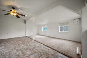 Unfurnished room with ceiling fan, baseboards, carpet, and stone finish flooring
