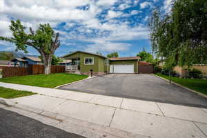 Ranch-style home featuring driveway and a garage