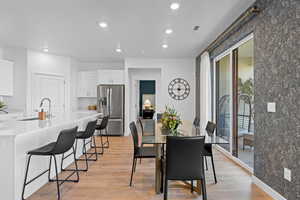 Dining area featuring recessed lighting, light wood-style flooring, and baseboards