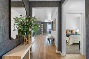 Hall with wood finished floors and baseboards