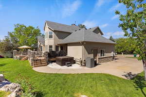 Rear view of property with a hot tub, composite deck, and RV parking