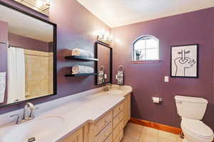 Full bathroom with tile floors and double vanity