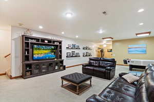 Carpeted living area featuring baseboards and recessed lighting