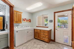 Laundry area featuring cabinet space and entry to the deck in the back yard