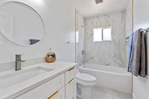 Full bath with vanity, shower / tub combination, toilet, and tile patterned floors