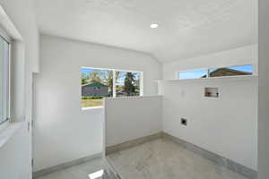 Washroom featuring hookup for an electric dryer, hookup for a washing machine, baseboards, a textured ceiling, and recessed lighting