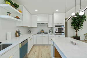 Kitchen featuring oven, dishwashing machine, recessed lighting, white gas cooktop, and light wood finished floors
