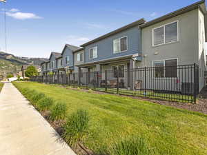 Back of property featuring fenced yard and stucco siding