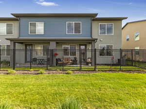 Back of house with stucco siding and fenced yard