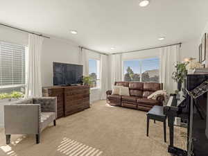 Carpeted living area with recessed lighting