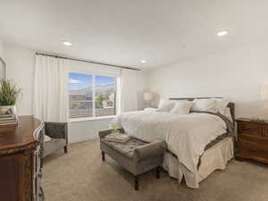 Bedroom with light carpet, recessed lighting, and baseboards