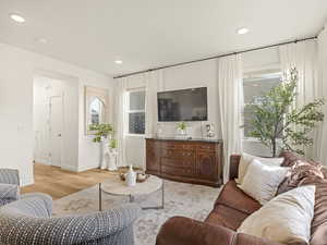 Living room featuring light wood-style flooring, recessed lighting, and baseboards