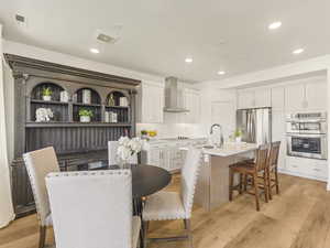Dining space with light wood-style flooring and recessed lighting