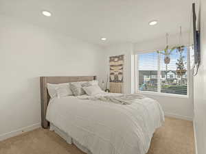Bedroom with carpet, baseboards, and recessed lighting