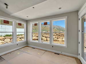 Unfurnished sunroom featuring healthy amount of natural light