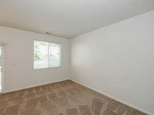 Unfurnished room featuring carpet and baseboards