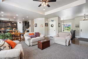 Living room featuring a chandelier, baseboards, ceiling fan, recessed lighting, and a textured ceiling