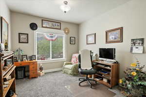 Office space with carpet flooring and baseboards