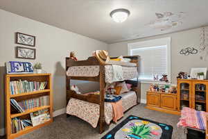 Bedroom featuring carpet flooring and baseboards