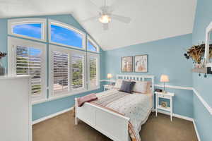 2nd of 4 second-floor bedrooms featuring lofted ceiling, carpet, multiple windows, and baseboards