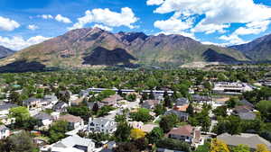 Aerial overview of property's location featuring a mountainous background and nearby suburban area