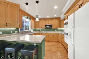 Kitchen featuring double ovens, a peninsula cooktop, and hardwood floors