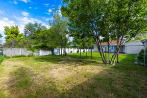 Fully fenced section of yard. Perfect for a dog run or detached garage with access from the alley.
