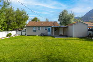Rear view of property with storage shed