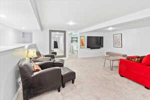 Living room featuring carpet, recessed lighting, and baseboards