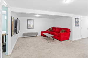 Carpeted living room with baseboards