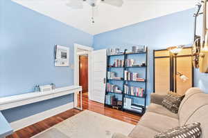 Office area with ceiling fan, wood finished floors, and baseboards