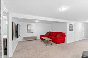Carpeted living room featuring baseboards