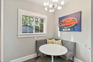 Dining space featuring baseboards and a chandelier