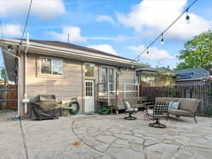 Back of property with a patio area, a fenced backyard, and outdoor lounge area