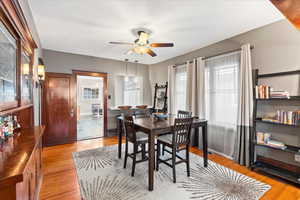 Dining room featuring a ceiling fan, light wood-type flooring, and baseboards