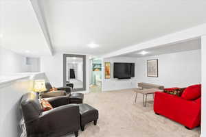 Living room featuring carpet, recessed lighting, and baseboards