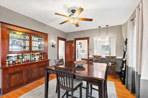 Dining room with a ceiling fan, light wood-type flooring, and plenty of natural light