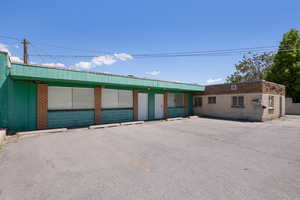 View of building exterior with uncovered parking