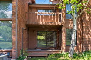 Rear view of house with a balcony and central air condition unit