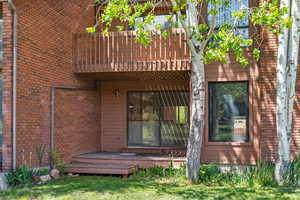 Entrance to property featuring brick siding