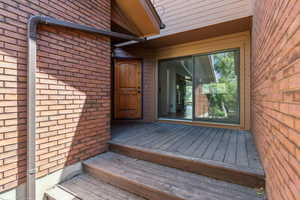 Entrance to property featuring brick siding