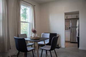 Dining space featuring light wood-style floors and baseboards