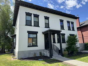 View of front facade featuring a front lawn and brick siding