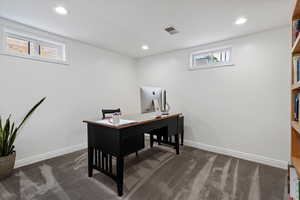 Lower level office with recessed lighting.