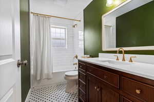 Main floor full bath with custom vanity, subway tile, and mosaic tile floor
