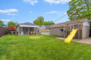 View of yard featuring a playground and a patio