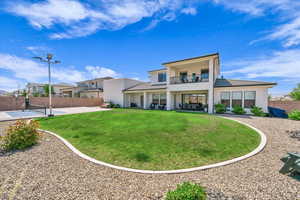 Rear view of property with a balcony, stucco siding, a patio, and an outdoor living space